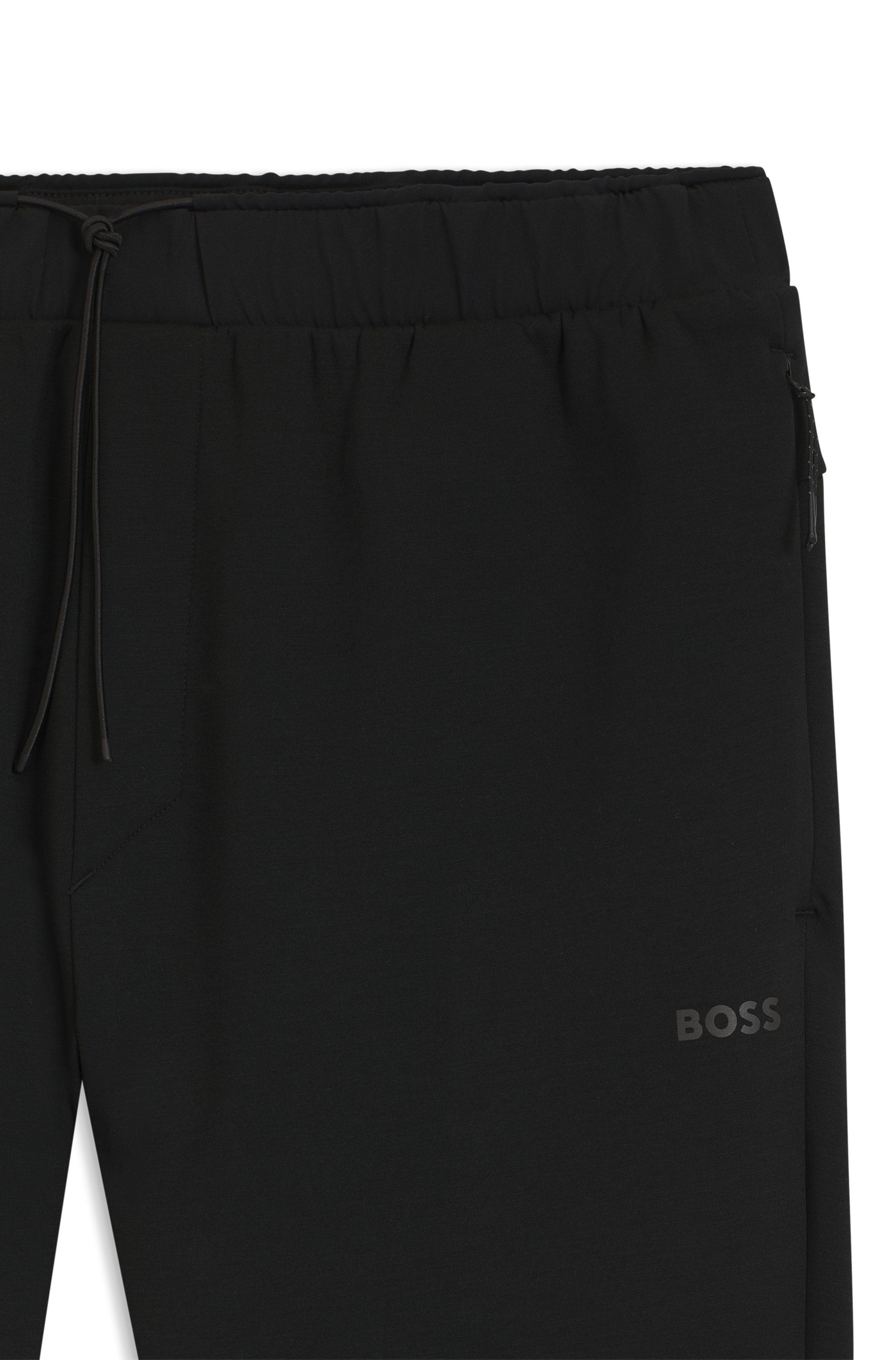 Teplákové kalhoty regular střihu s reflexními detaily - Black